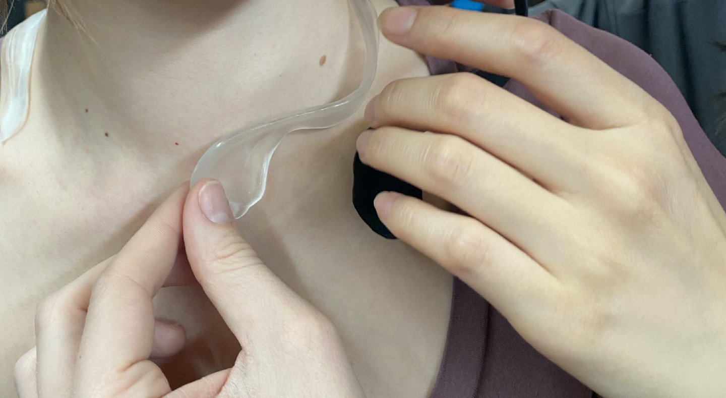 Haptic device prototype being placed on the body during embodied testing