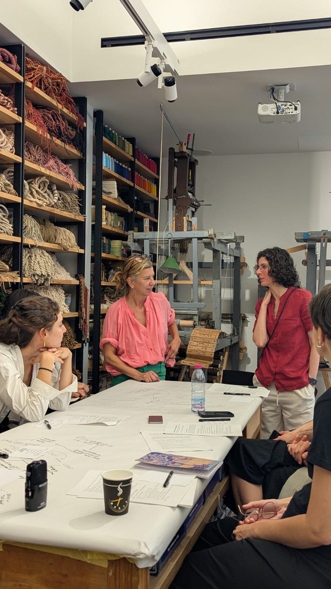 Workshop discussion at The Making of Creativity, surrounded by looms and yarn